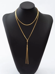 Detail of golden double-layer snake chain necklace with lariat style slider clasp