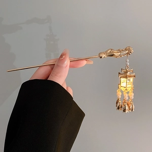 Glow-in-the-dark lantern hair pin with pearl tassels and traditional gold finish