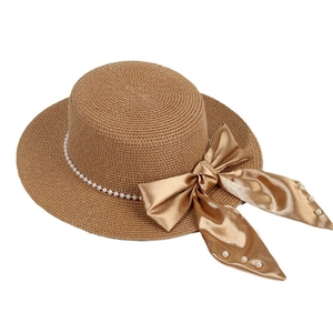 Elegant summer flat top straw hat with pearl band and large champagne gold satin bow