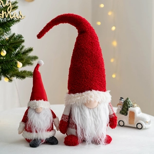 Christmas gnomes figurines with knitted hats in red and white festive holiday decor