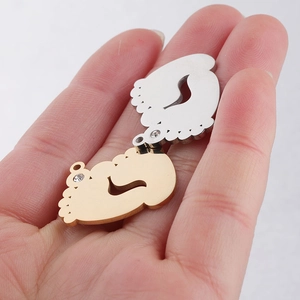 Polished stainless steel baby feet pendants in gold and silver with rhinestones