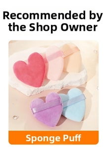 Close-up of heart-shaped makeup sponges in multiple colors on a textured stone