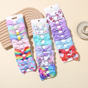Set of 27 handmade baby ribbon bow hair clips with rainbow and floral patterns