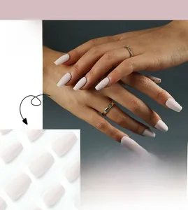 Close-up of matte pale pink coffin shape press-on nails in a solid minimalist style
