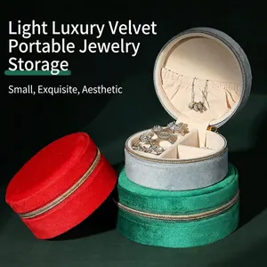 Mini velvet jewelry organizer boxes in red, grey, and green for rings and necklaces