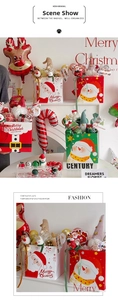 Close-up of festive Christmas gift bags with Santa Claus designs and plush ornaments