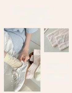 Close-up of sweet ballet style socks with vertical ribbed texture and cute bow details
