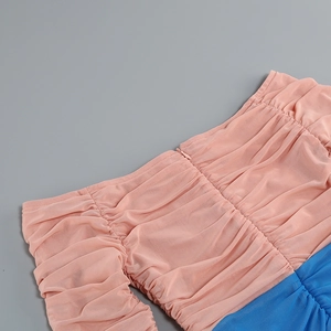 Detail of pink and blue mesh dress showing ruched fabric texture and invisible zipper