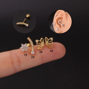 Detailed view of gold flower, butterfly, and curved zircon stud earrings set