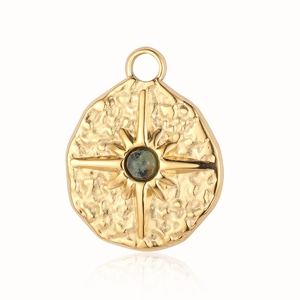 Detailed view of golden bohemian sun star pendant with green natural stone setting