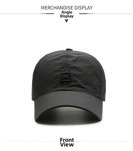Close-up of black baseball cap with breathable laser-cut holes and square logo patch