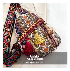 Close-up of bohemian woven chest bag featuring colorful geometric patterns and decorative tassels