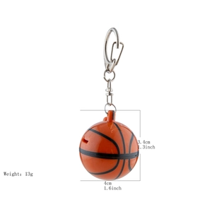 Detailed view of orange basketball keychain whistle with dimension and weight labels