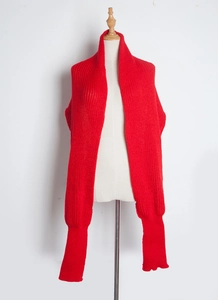 Detail of red knitted scarf with functional sleeve cuffs on a beige mannequin