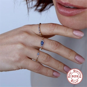 Macro detail of three 925 sterling silver rings set with blue sapphire and cubic zirconia