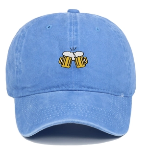 Close-up of beer glasses embroidery on washed blue cotton baseball cap texture