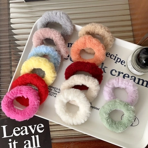 Plush faux rabbit fur scrunchies in 13 vibrant colors displayed on a white tray