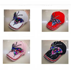 Detailed view of four denim baseball caps featuring crystal butterfly embroidery in various colors
