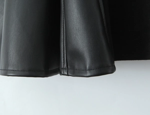 Detailed close-up showing precision stitching and premium black PU leather texture of the dress