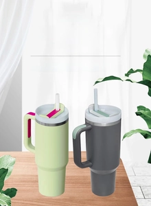 Dual 40oz stainless steel tumblers with handles and straws in mint and charcoal colors