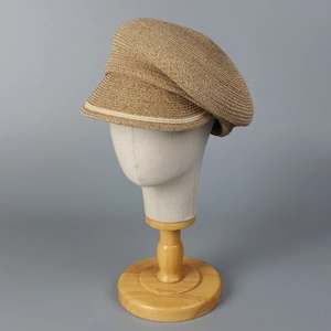 Brown woven straw newsboy hat with striped brim trim for summer sun protection