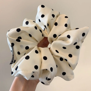 Oversized cream scrunchie with black polka dots featuring elegant ruffled layers