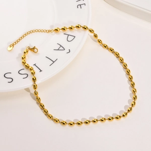Detail of 3/5mm golden titanium steel olive bead necklace with lobster clasp and chain
