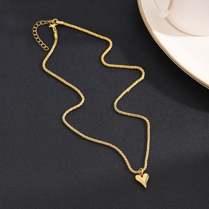 Detail view of a gold heart pendant necklace with sleek snake chain and lobster clasp