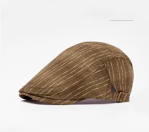Detail of army green striped flat cap showing texture and adjustable brass metal buckle