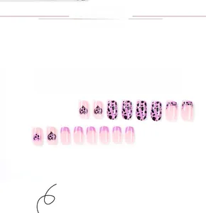 Detail of purple leopard print and black heart patterns on pink press-on nails
