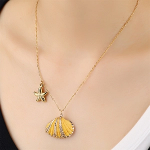 Golden beach necklace with yellow shell and starfish pendant on a female model