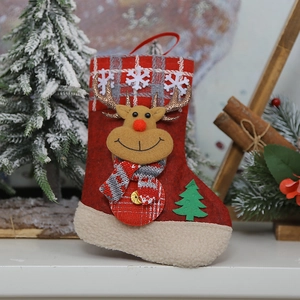 Close-up of red felt Christmas stocking with 3D reindeer doll and snowflake patterns