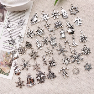 Macro detail of vintage silver Christmas alloy charms for DIY holiday jewelry making