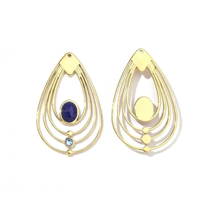 Detail showing gold teardrop earrings with multi-layer circles and blue gemstone inlay