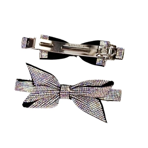 Elegant crystal rhinestone bow hair clip with luxury metal spring clip on white background