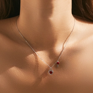 Elegant S925 sterling silver necklace with a red heart lock and key pendant on a model