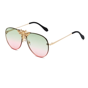 Golden bee pilot sunglasses with green-to-pink gradient lenses and metal frame