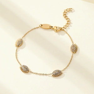 Gold titanium steel bracelet featuring four zircon-inlaid evil eye pendants for women