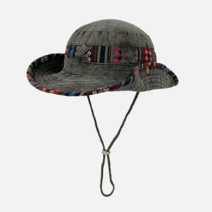 Detail of dark gray outdoor bucket hat featuring ethnic pattern ribbon and windproof cord