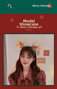 Detail of Christmas reindeer antler headband with golden glitter and red pompom on model