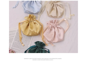 Detailed view of colorful satin drawstring bags for gift packaging and cosmetics