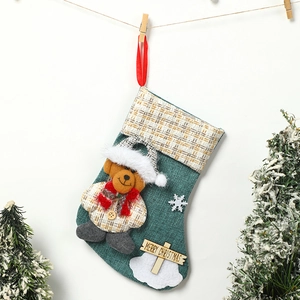 Detail of green linen Christmas stocking with 3D teddy bear and wooden Merry Christmas sign