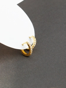 Macro detail of gold S925 silver hoop earrings with clear pavé cubic zirconia