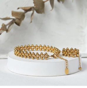 Detail of multi-layer gold beaded bracelet with lobster clasp and K18 hallmark tag