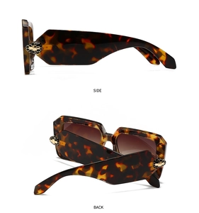 Detail of tortoise shell square sunglasses with gold snake head emblem and gradient lenses