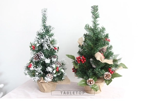 Tabletop snowy mini Christmas trees with pine cones, red berries and burlap bases