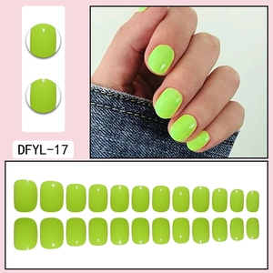 Short neon green fake nails set showing 24 pieces layout and hand-worn model effect
