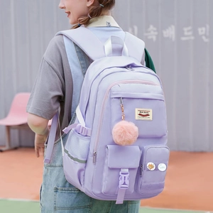 Detail view of large lavender nylon backpack with side buckle and mesh pocket for student
