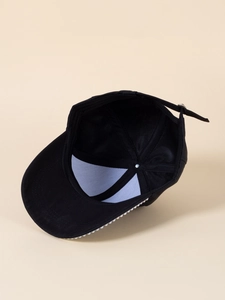 Detailed interior view of a black baseball cap featuring an adjustable strap and soft cotton fabric