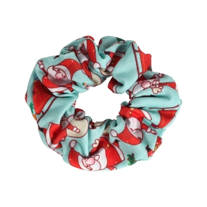 Close-up of light blue Christmas scrunchie featuring a Santa Claus pattern and texture